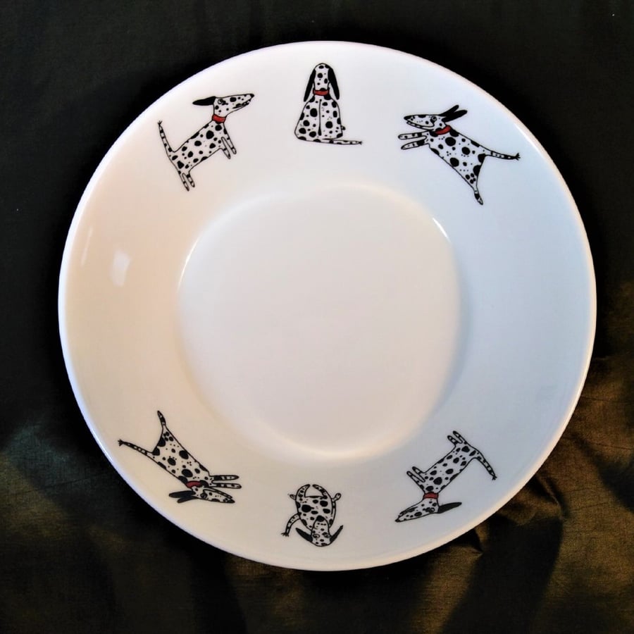 A dessert or soup bowl or dish of white bone china decorated with six Dalmatian 
