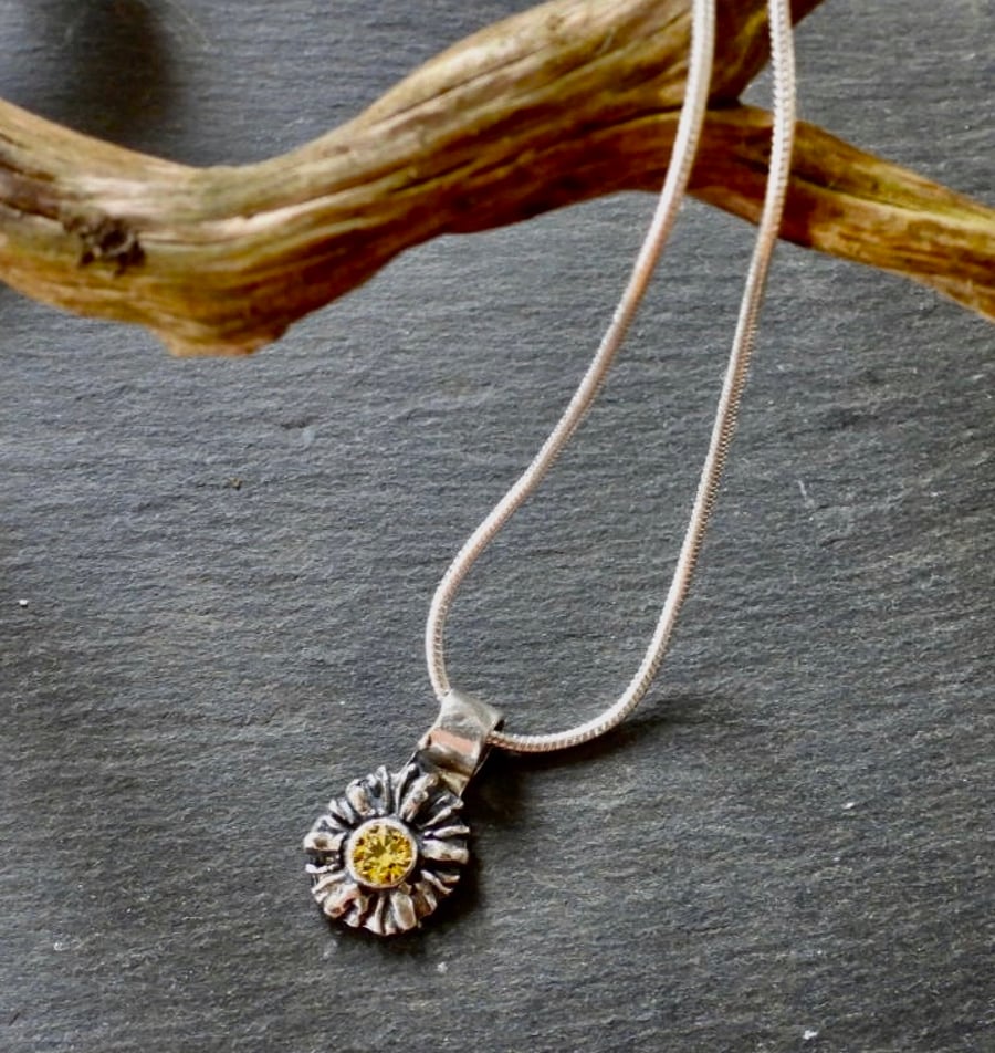 Summer Days, Daisy Necklace, with a yellow stone in the centre.