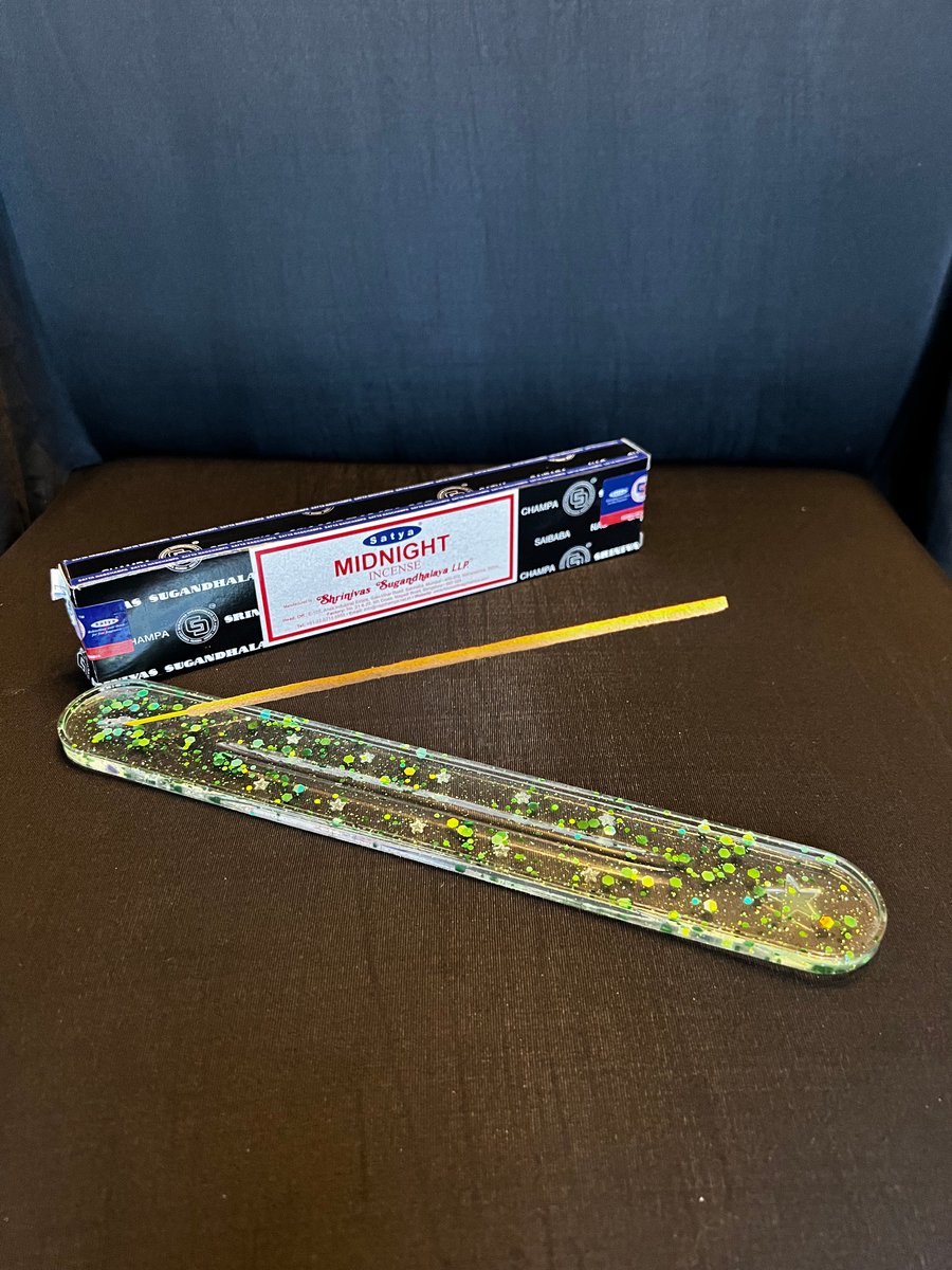 Clear resin with green glitter incense holder.