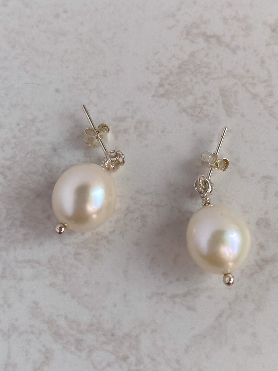 Large pearl earrings.