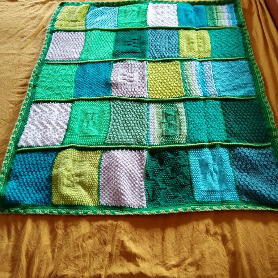 baby and toddler handmade knitted baby blanket in green colourway.