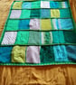 baby and toddler handmade knitted baby blanket in green colourway.