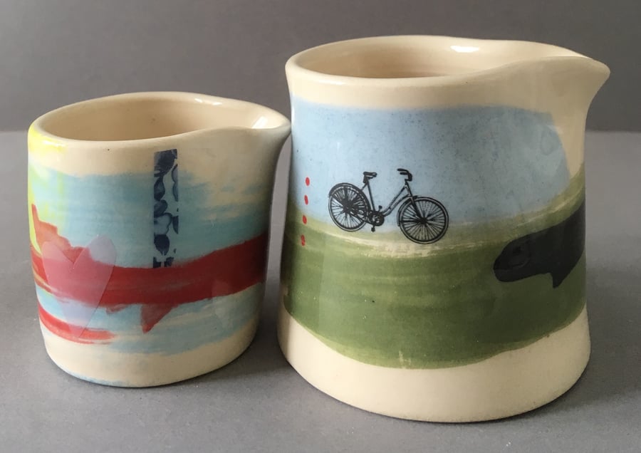 2x Ceramic jug. Cyclist. Milk Jug. Pourer. Bike. Cream jug. Gravy. Sauce.