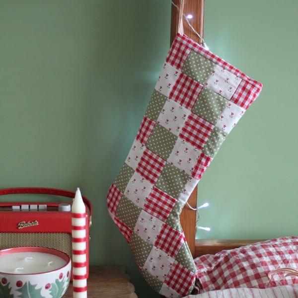 Patchwork Christmas stocking in shades of red, green and cream. Postage included