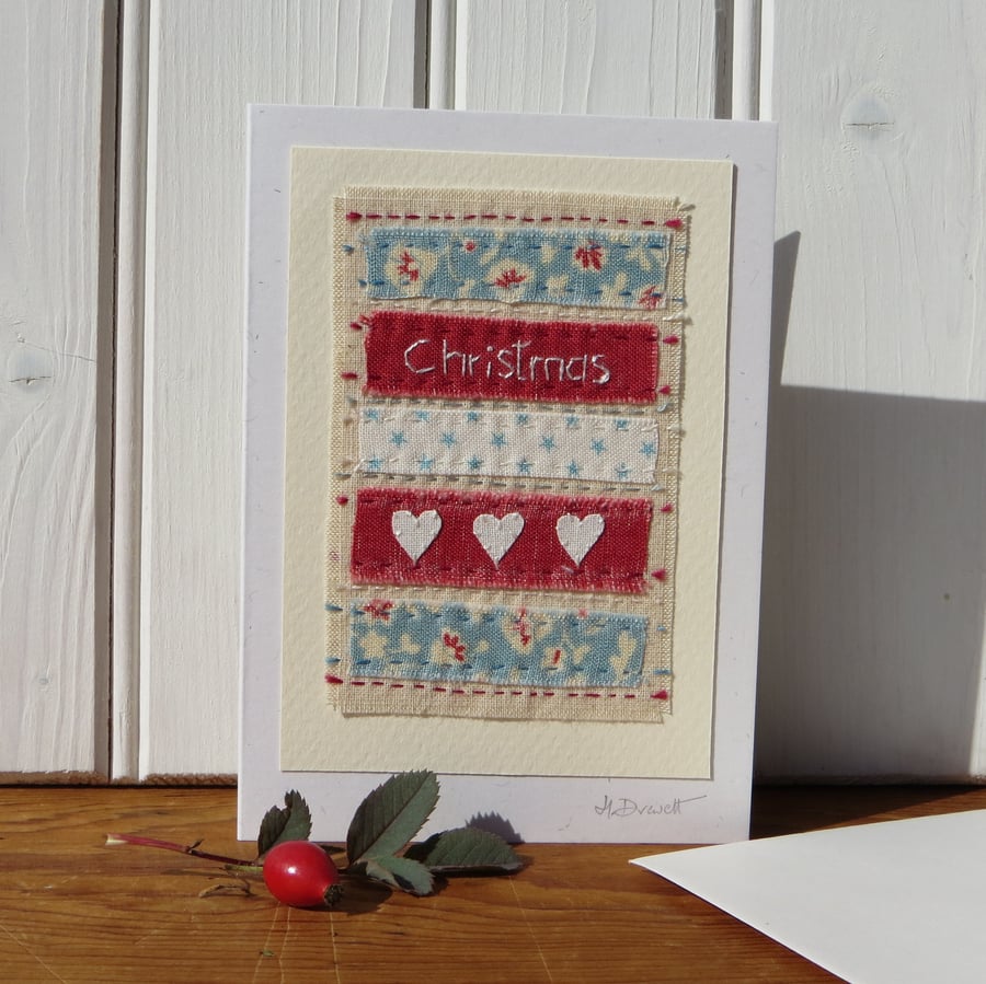 Hand-stitched Christmas card with three little hearts and pretty fabrics