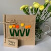 Easter greeting card with row of orange and yellow flowers. Handmade. Wool felt.