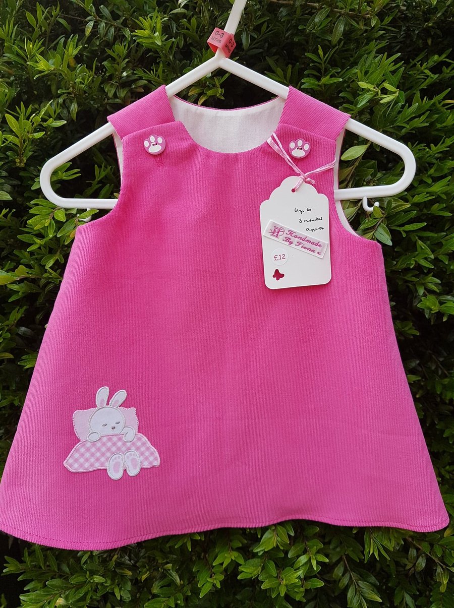 Age: 0-3m. Rose pink baby needlecord pinafore dress. 