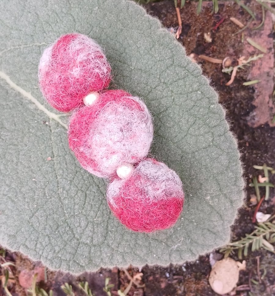A felted bar brooch with faux seed pearls