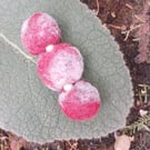 A felted bar brooch with faux seed pearls