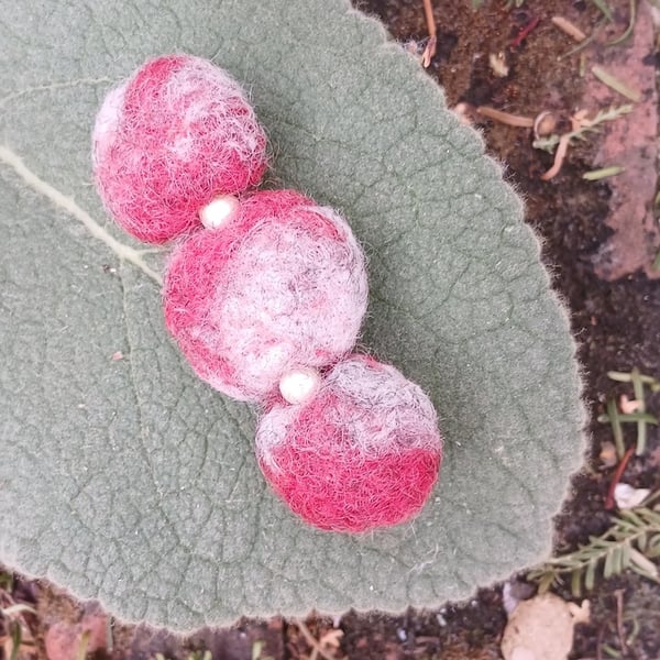 A felted bar brooch with faux seed pearls