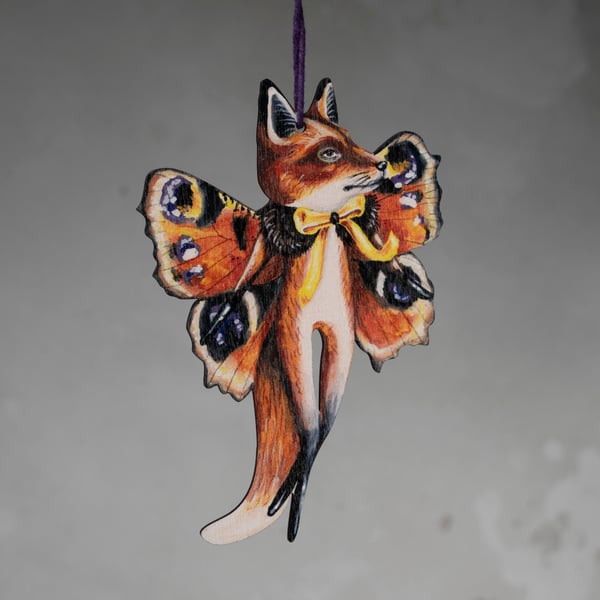 Wooden hanging ornament of a fox butterfly called Kevin. Double sided