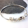  Silver garnet and 18ct gold bangle