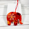 Red and orange fused glass elephant hanging.