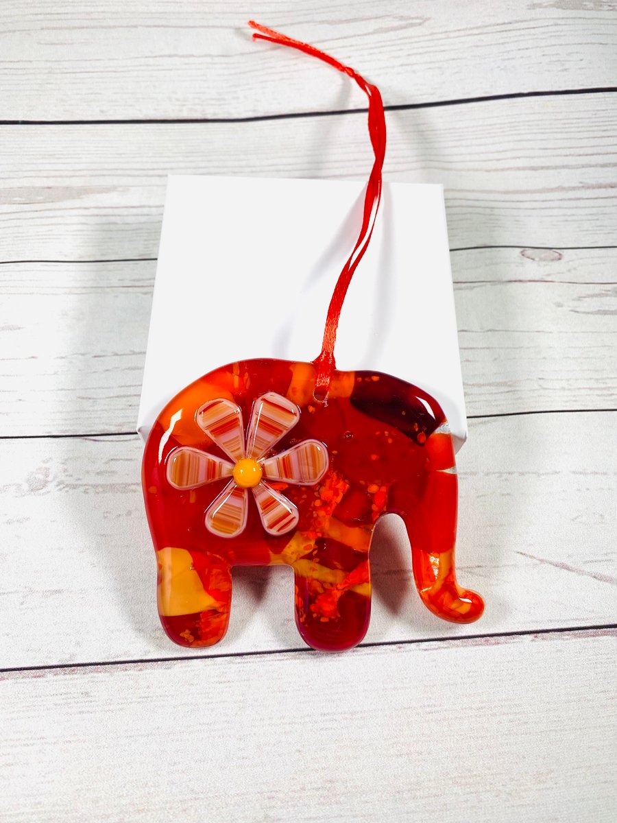 Red and orange fused glass elephant hanging.