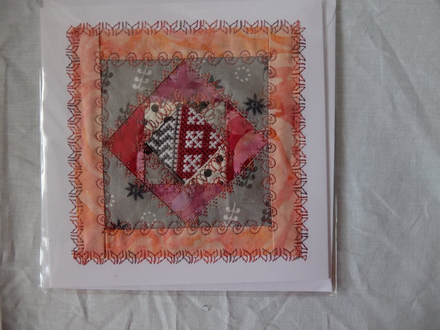 Hand made greetings card, quilt block around fragment of cross stitch