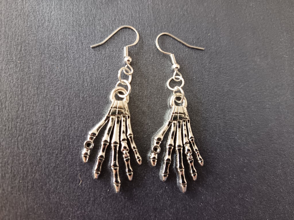 Silver skeleton hand dangle earrings 