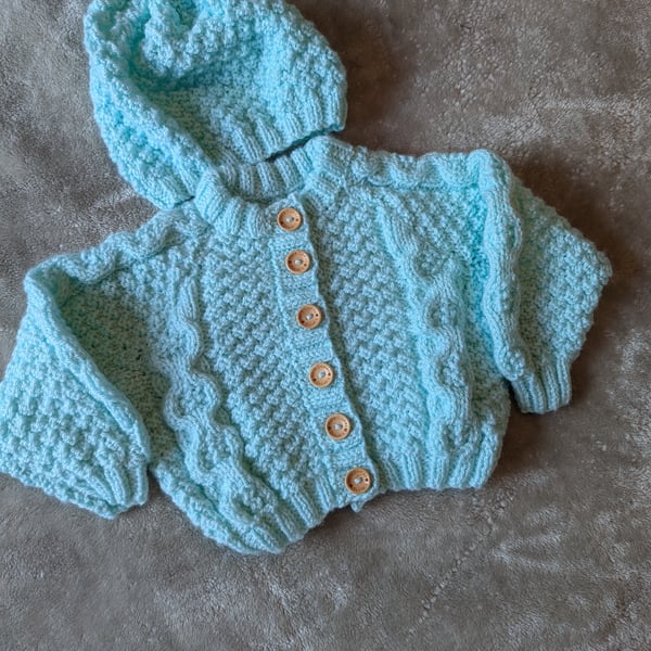 Baby's cable cardigan with matching hat 