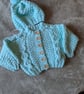 Baby's cable cardigan with matching hat 