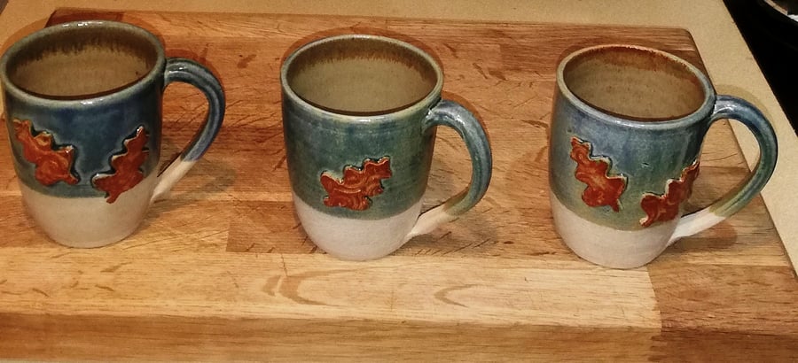 Generous and beautiful oak leaf decorated stoneware mugs