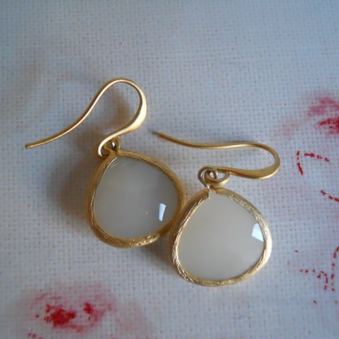 Gold framed white earrings