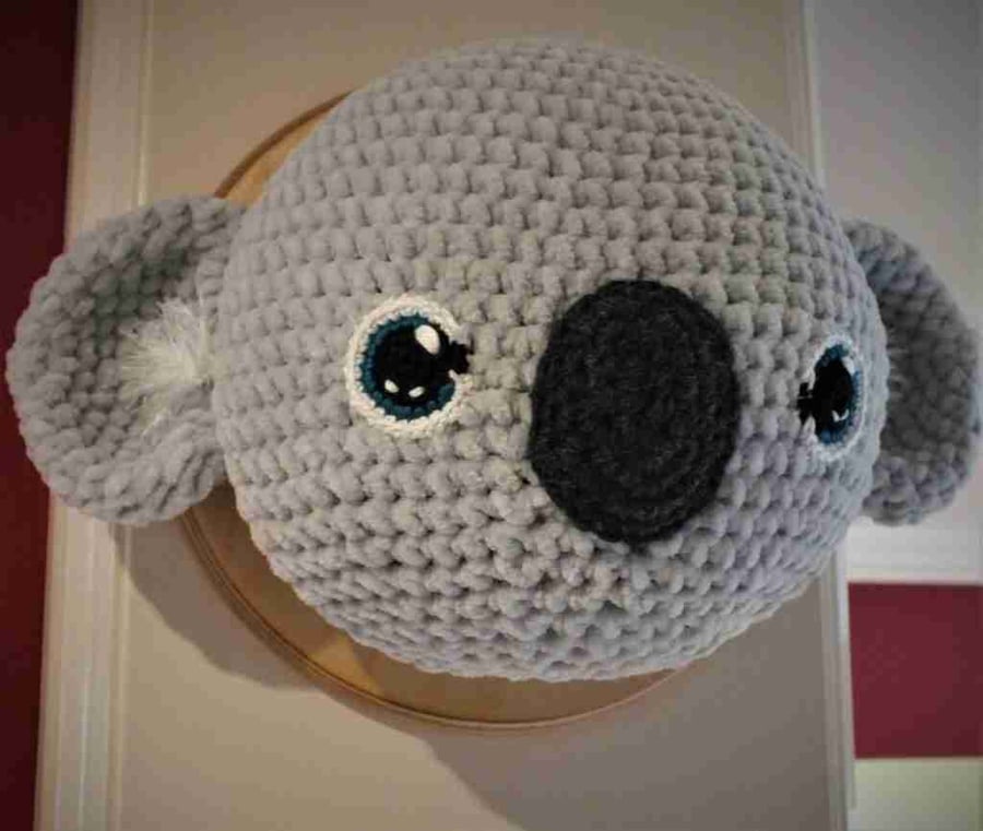 Crocheted koala trophy head on wooden board