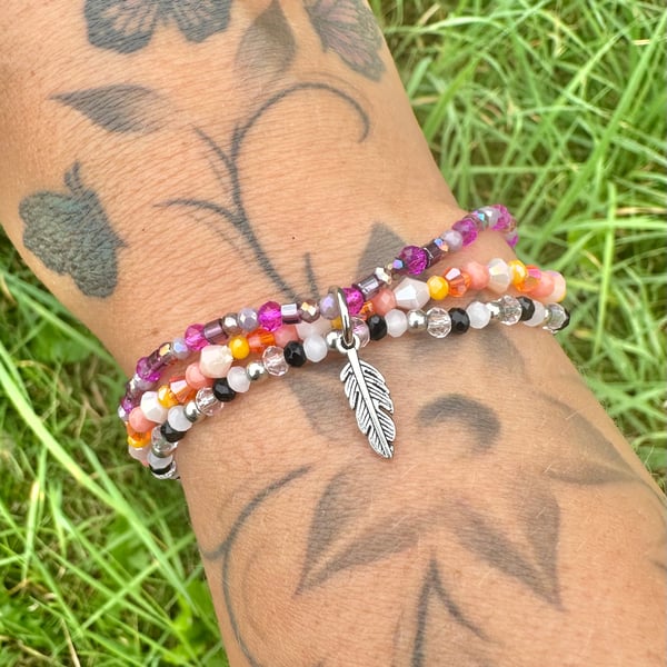  Beaded bracelet set with hanging feather charm 
