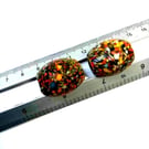 Two giant end of day barrel shaped splatter beads