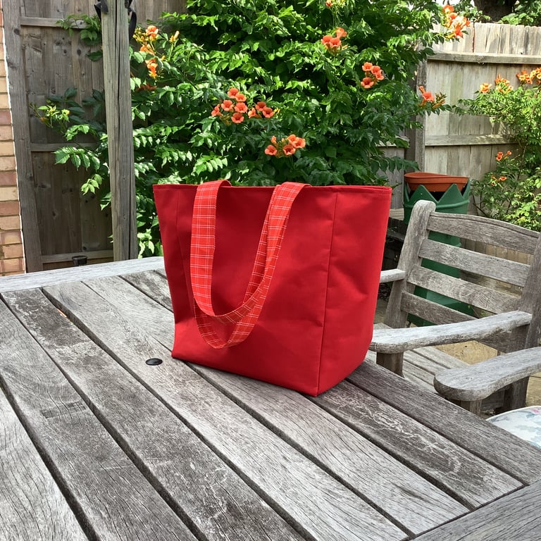 Lovely red water resistant bag, shoulder straps, reinforced base.