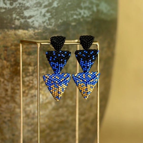 Hand beaded modern black, blue and gold drop earrings in a geometric design.