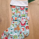 Christmas stocking with animals and Father Christmas