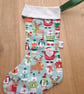 Christmas stocking with animals and Father Christmas