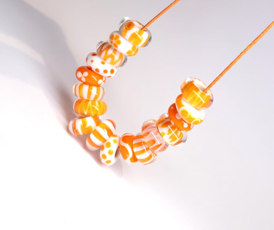 Handmade orange and white patterned lamp work glass beads