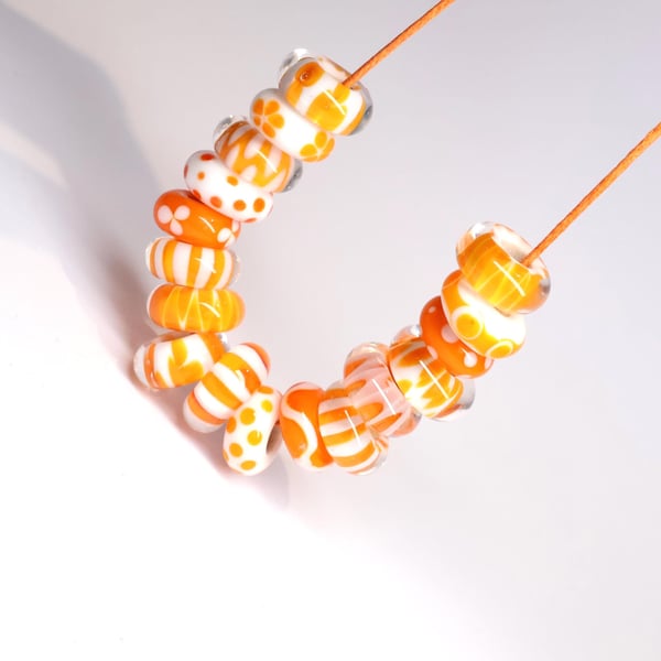 Handmade orange and white patterned lamp work glass beads