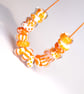 Handmade orange and white patterned lamp work glass beads - Image 1