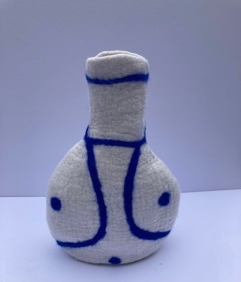Blue and white felted long necked vase.