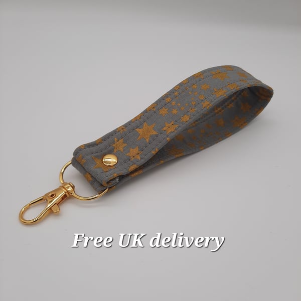 Key fob wristlet - grey with gold stars. Sale. 