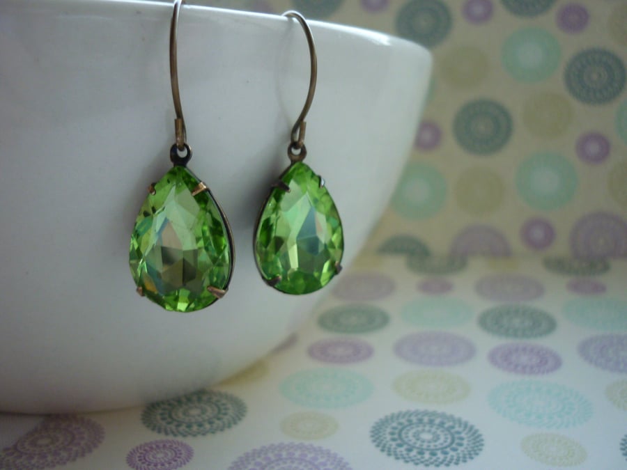 PERIDOT GREEN AND PATINA BRASS PEAR TEARDROP RHINESTONE EARRINGS.  973