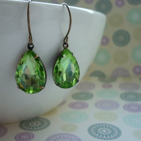 PERIDOT GREEN AND PATINA BRASS PEAR TEARDROP RHINESTONE EARRINGS.  973