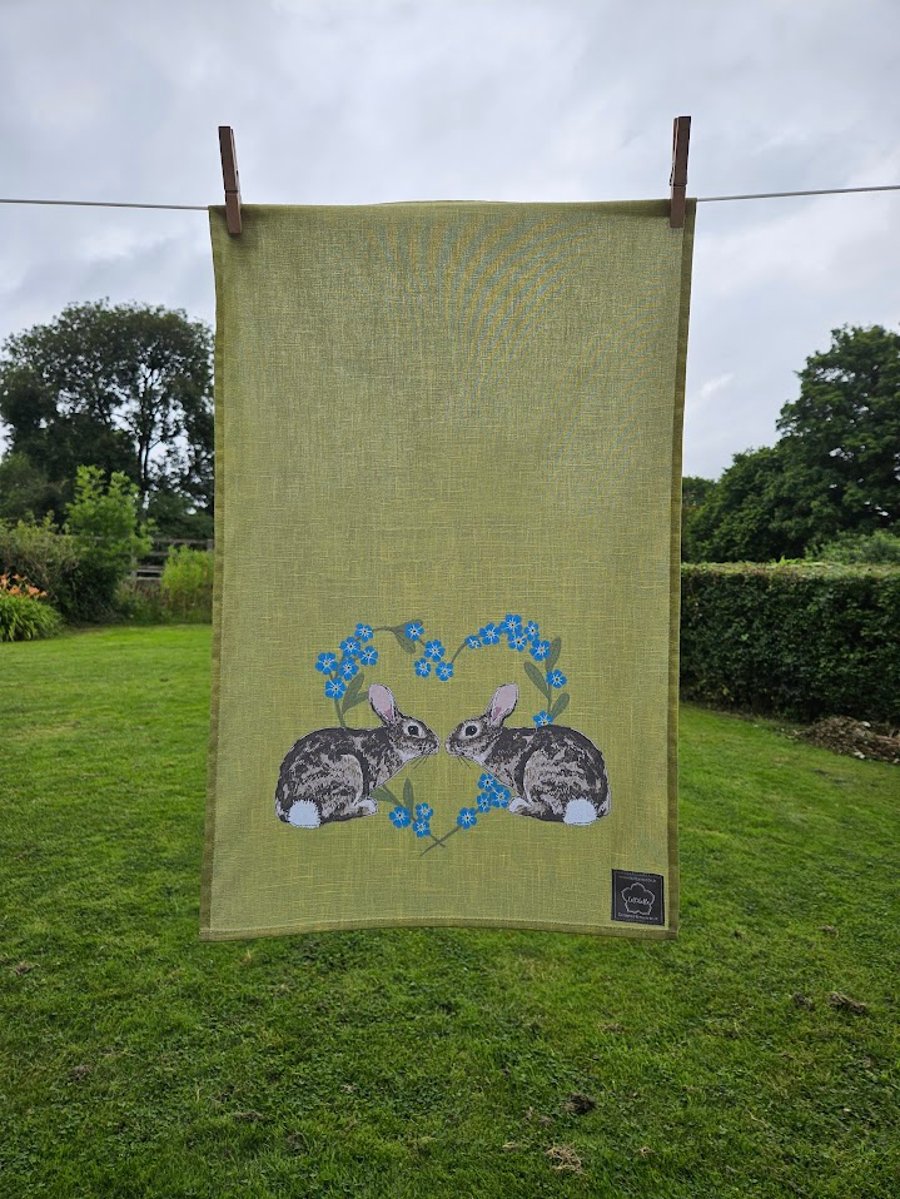 Rabbits in forget-me-not heart tea towel design, organic cotton, hanging loop