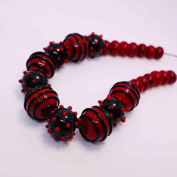 Handmade red and black lamp work glass beads