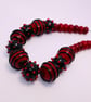 Handmade red and black lamp work glass beads