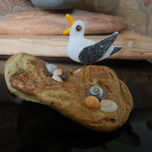 Handmade Fused Glass 'Seagull on Beach Stone' ornament.