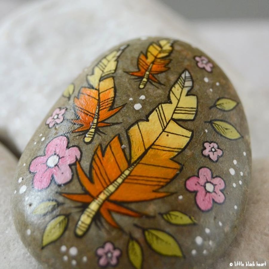 floating golden feathers - painted pebble