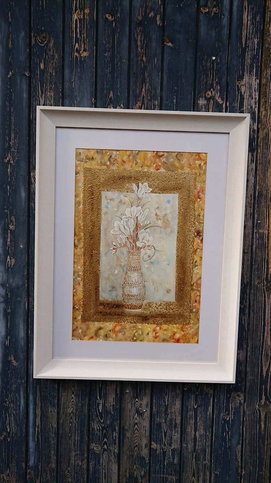 White freesia painting in gilt vase with gold decorative work border.