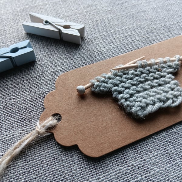 Handmade gift tag with tiny knitted jumper in grey wool New Baby