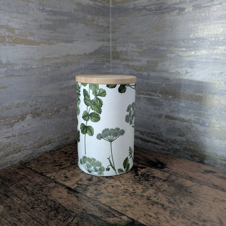 Decoupaged glass jar with wooden lid decorated with a herbal theme