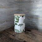 Decoupaged glass jar with wooden lid decorated with a herbal theme