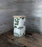 Decoupaged glass jar with wooden lid decorated with a herbal theme