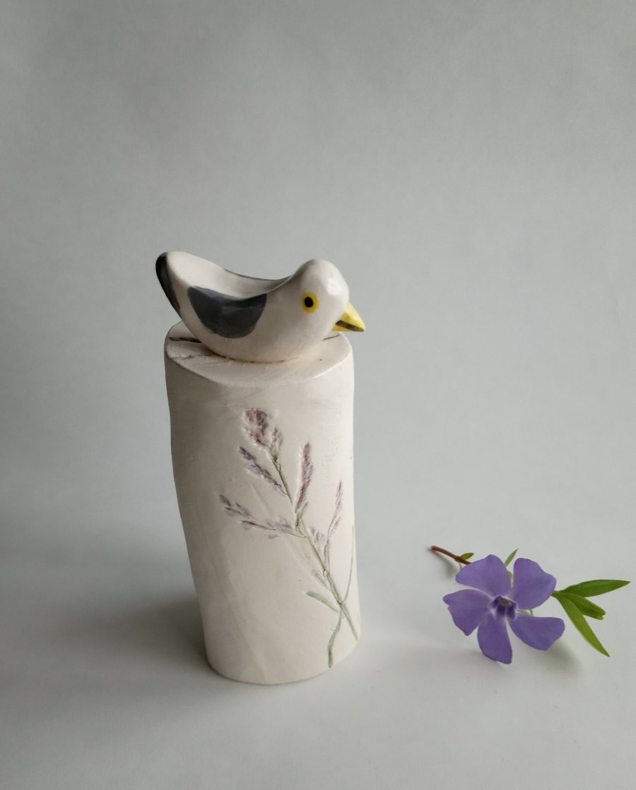 ceramic seagull on a floral plinth