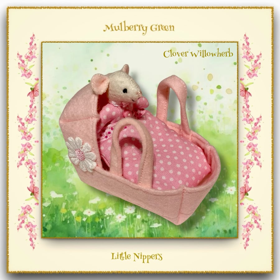 A Baby Pip Squeak in a Pink Carry Cot